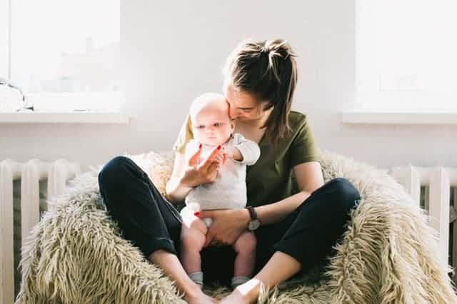 Image of a mother sitting with baby to illustrate therapy for postpartum depression and anxiety in Houston, TX 77006