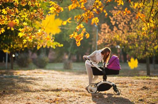 Photo of woman checking her stroller. Postpartum anxiety counseling in Houston, Tx 77006