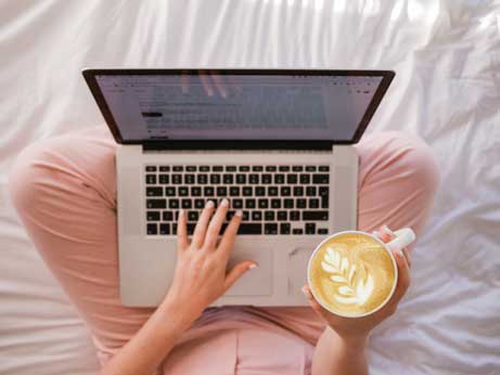 Women at laptop to illustrate telehealth therapy Houston, Texas 