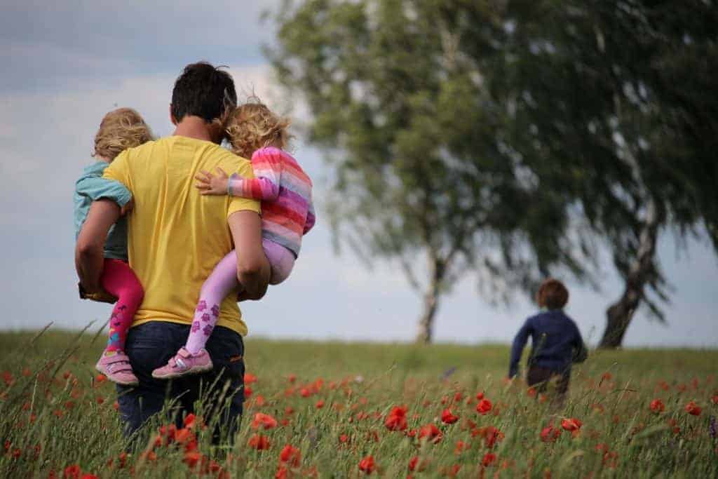 Photo of man holding children to illustrate tips for connecting with your child