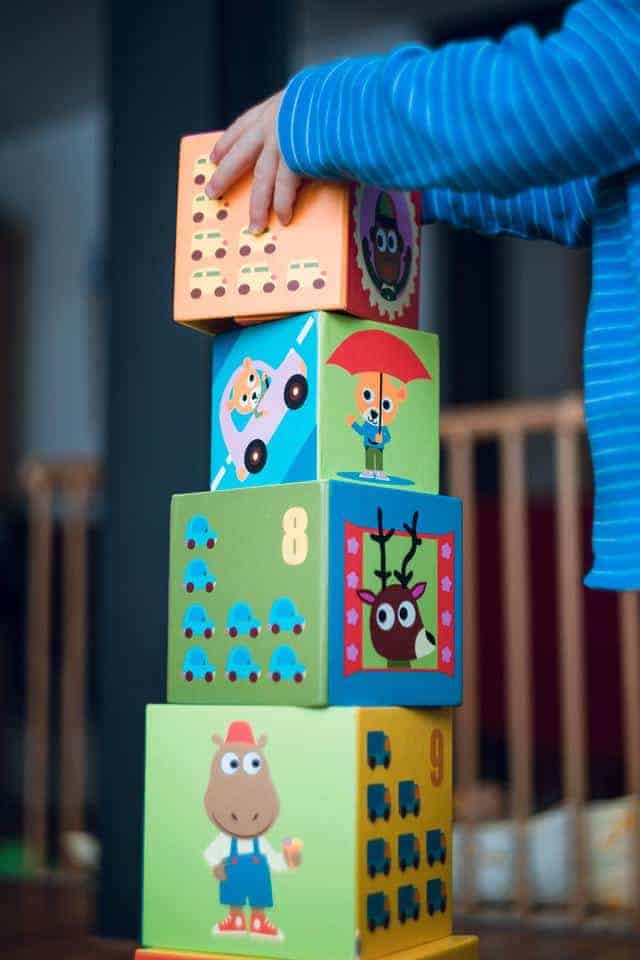 Photo of child stacking blocks to illustrate steps of trauma treatment for children Houston Texas