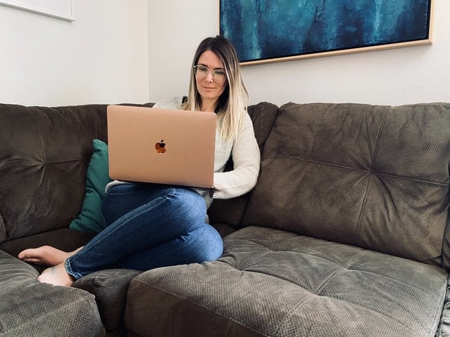 Photo of woman sitting with laptop to illustrate telehealth therapy for anxiety in Houston Texas