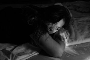 Picture of a woman lying down to illustrate postpartum depression 