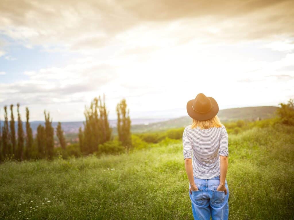 Woman looking into sky with hope to illustrate therapy for infertility and pregnancy loss